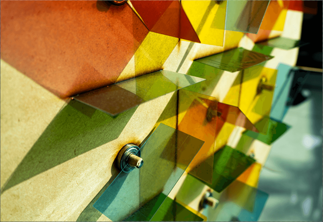 Laser-cut colored acrylic panels catching sunlight